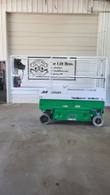 JLG 1930ES scissor lift stowed with the platform extension deck slid out to the left, side view