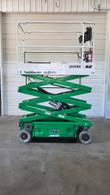 JLG 1930ES scissor lift with the platform partly raised, showing the green scissor stack and lift cylinder