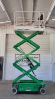 JLG 1930ES scissor lift raised to full height, platform on the extended scissor stack in the shop