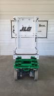 JLG 1930ES scissor lift stowed, opposite end view with the JLG logo on the platform rail panel