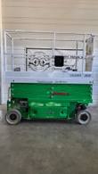 Green and gray JLG 2632ES electric scissor lift, stowed, side view