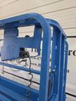 Genie GS-1930 platform control box with joystick mounted on the guardrail, coiled control cable
