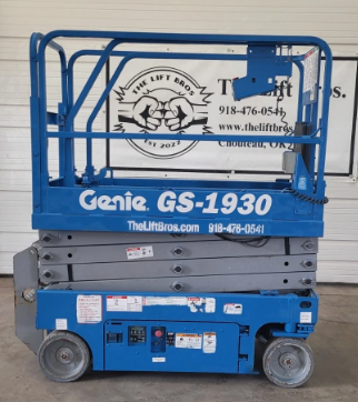 Genie GS-1930 scissor lift, side profile lowered: stacked scissor arms, guardrails and solid gray tires