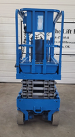 Blue Genie GS1930 scissor lift, fully lowered: platform guardrails, folded scissor stack and solid tires