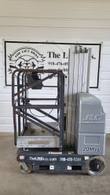 Gray JLG 20MVL vertical mast lift, stowed, side view with rusty guardrail platform and battery cover