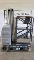 Gray JLG 20MVL vertical mast lift, stowed, opposite side view with platform, mast and drive wheel