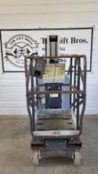 JLG 20MVL mast lift platform end, stowed: guardrails, platform controls and caster wheels