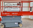 Skyjack SJIII 3219 with platform lowered, entry chain and control box on the rail, scissor arms stacked flat