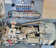 Open power compartment: hydraulic manifold and pump motor, relay and fuse board with wiring harness