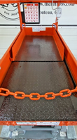 Skyjack platform deck from above: diamond-plate floor, slide-out extension deck and orange entry safety chain