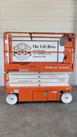 Orange Snorkel S3226E scissor lift, lowered, opposite side view with the platform control box on the right