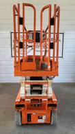 Snorkel S3226E scissor lift lowered, end view of the platform guardrails, operator's checklist decal and base
