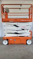 Orange Snorkel S3226E scissor lift with the platform raised part way, side view of the white scissor arms