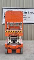 Snorkel S3219E scissor lift, stowed, opposite side view with platform rails