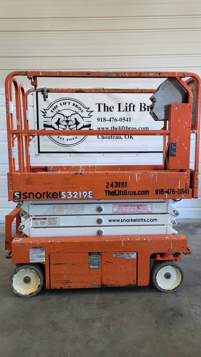 Orange Snorkel S3219E electric scissor lift, stowed, side view