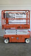 Orange Snorkel S3219E electric scissor lift, stowed, opposite side view