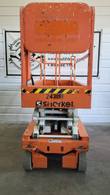 Orange Snorkel S3219E electric scissor lift, stowed, end view with Snorkel logo and hazard stripe on the platform