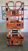 Orange Snorkel S3219E electric scissor lift, stowed, platform guardrails and control box facing the camera