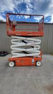 Snorkel S3226E scissor lift with the platform partly raised, showing the scissor stack