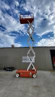 Snorkel S3226E electric scissor lift, platform fully raised, straight-on front view