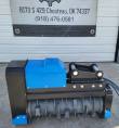Blue Raytree excavator drum mulcher side-on: gray toothed rotor drum, blue housing and pin-on mount