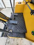 AGT H15 operator deck with quilted black floor mats, steel foot pedals and the yellow control console