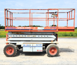 SkyJack SJ 7127 rough terrain scissor lift, orange guardrails and slide-out deck extension on lug tires
