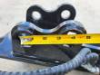 Tape measure across the sickle mower's mount head pin ears, spanning about 5 inches