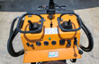QB-480 mini skid steer control console: twin joysticks, fuel and hour gauges, key start and headlight switch