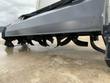 Curved tines arranged beneath the tiller for bi-directional cutting and ground penetration.