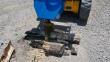 GIYI cone log splitter on a yellow skid steer, screw cone driven into wood with shavings