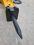 SB40's lower end: black chisel bushing housing with the moil point chisel fitted