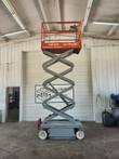 Skyjack SJIII 3219 scissor lift fully raised, scissor stack extended indoors