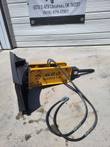 Agrotk 680 breaker on quick-attach bracket with two hydraulic hoses and metal fittings.