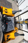 MIVA VA15 operator station with twin joysticks, key switch, gauge panel and a plastic-wrapped seat with belt