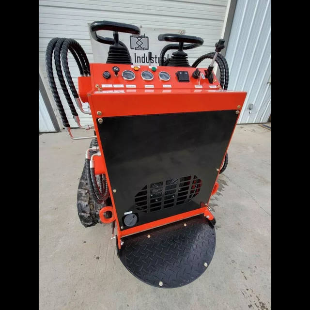 AGT LRT23 mini skid steer from behind: red frame, black engine cover, gauge panel and diamond-plate stand-on platform