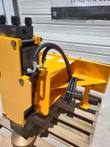 Post driver hydraulic top: valve block with IN port, 90-degree fittings, coiled supply hose and frame