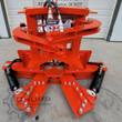 Orange TopCat tree shear: V-shaped cutting blades, clamp arms and hydraulic quick-couplers on top