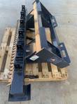 Wolverine ripper bar from above: quick-attach frame with brand decal, pinned shank brackets and rake tines