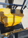 Four booted hand levers on the MX12RX mini excavator control stand, above the rubber floor mat and the seat
