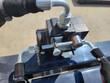 Hydraulic coupler block on top of the bucket with the supply and return hoses connected.