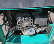 MH13RX engine bay: OHV gasoline engine with caged muffler, air cleaner and hydraulic hoses behind mesh screens