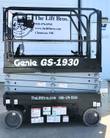Refurbished Genie GS-1930 scissor lift in black with Lift Bros decals, lowered, guardrails and non-marking tires
