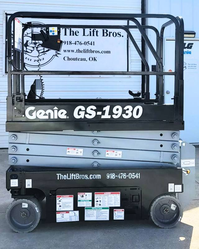 Refurbished Genie GS-1930 scissor lift in black with Lift Bros decals, lowered, guardrails and non-marking tires