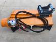 Orange Wolverine flail mower with black excavator mount bracket, hydraulic motor and sleeved hoses