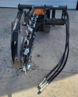 JCT trencher digging wheel with teeth, hydraulic drive motor and coiled hoses at the mount