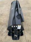 Wolverine tiller attachment, overhead view of tines, mount plate, and safety warning labels