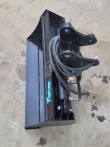 Black Future hydraulic tilt bucket from above, twin-eared tilt head with armored hoses coiled