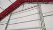 Interior of the fabric building: galvanized steel dual-truss arches, purlins and cross-cabling under the PVC cover