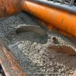 Landhonor cement mixer drum turning wet concrete, orange paddle shaft working through the batch; example photo